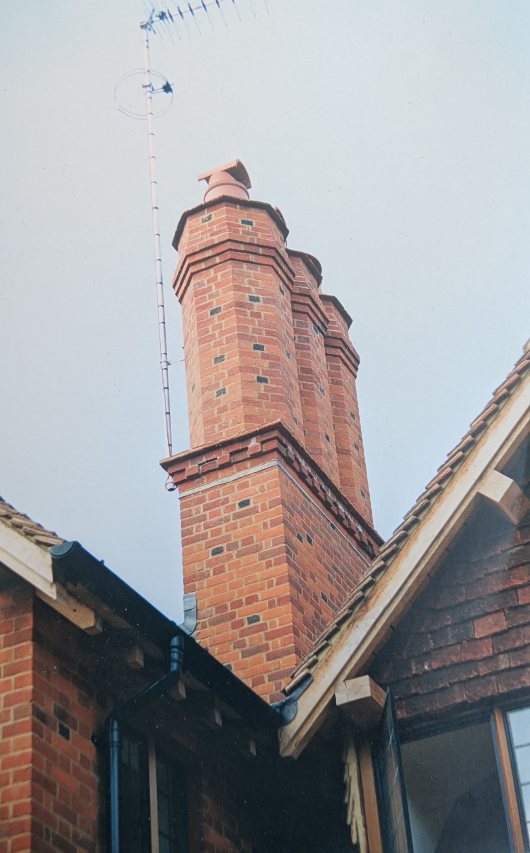 Traditional multi-flue brick chimney stack with terracotta pots, built by MMA Construction
