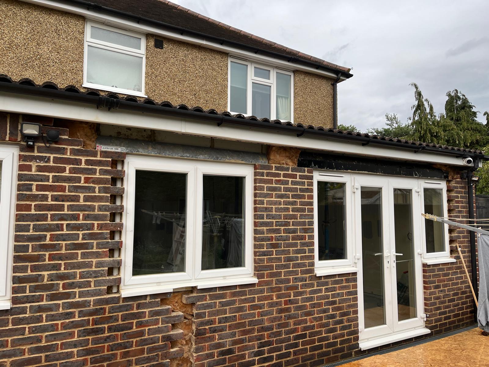 Full rear elevation partway through the conversion, showing new brickwork alongside the original wall