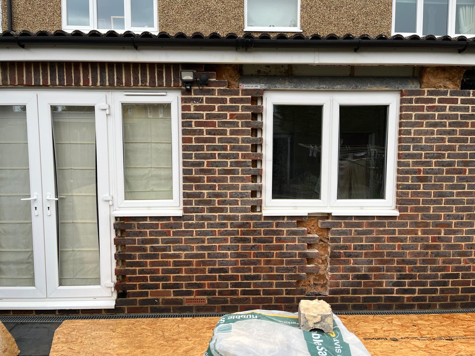 Close-up of new brickwork toothed into the existing wall, ready to tie the two together seamlessly