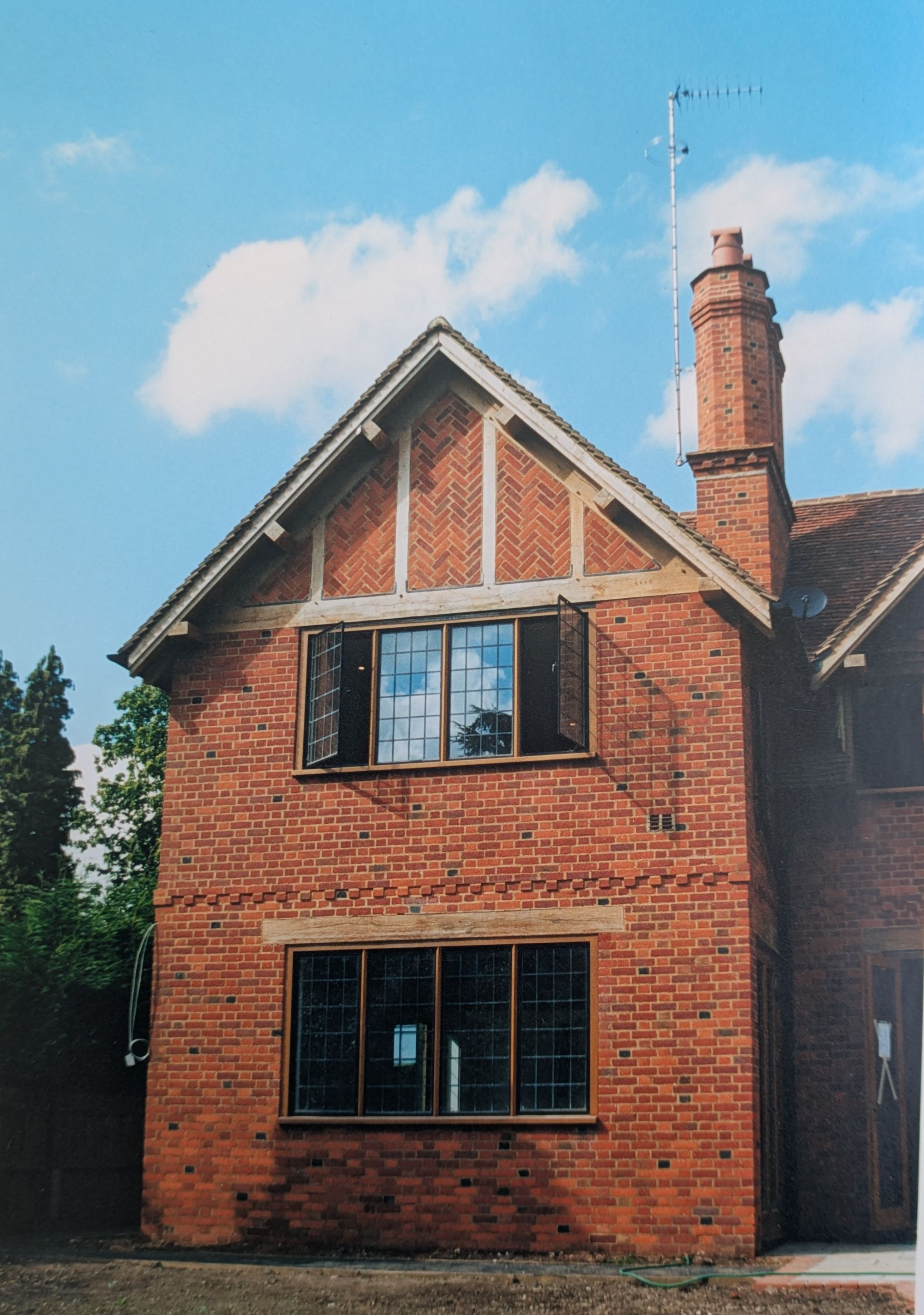 Herringbone brick infill panel set within an oak-framed gable